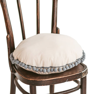 MINICAMP apvali dekoratyvinė pagalvėlė su pilkais pomponais, skirta vaikų kambariams ir gyvenamosioms patalpoms